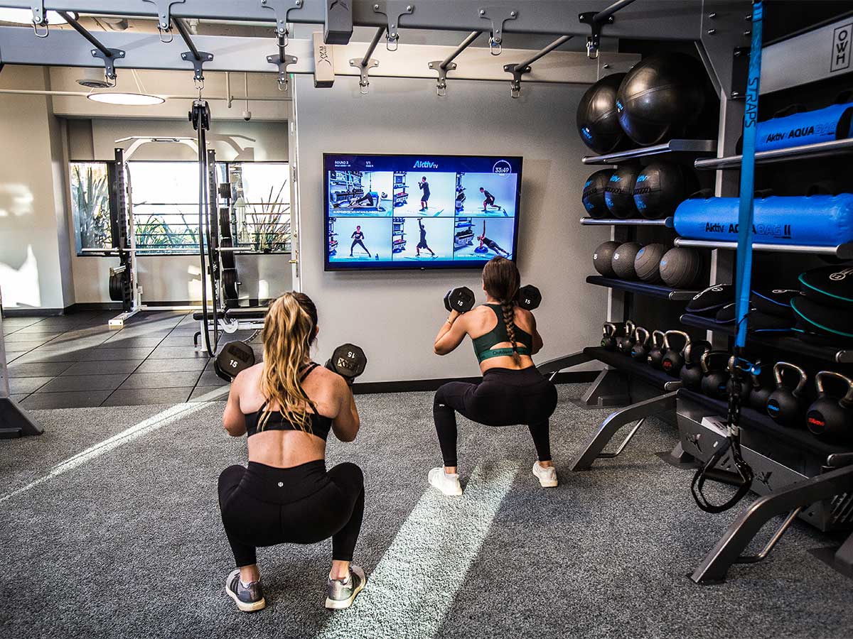 Two girls working out with AktivTV exercise guidance.