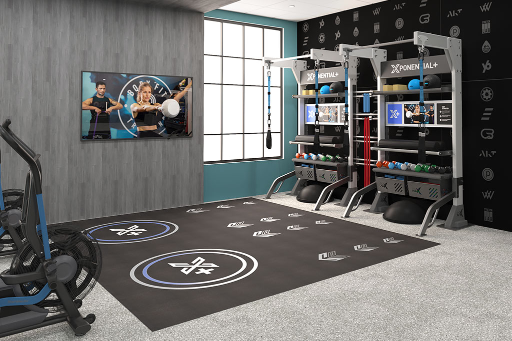 Xponential+ Functional Fitness on gym TV in amenity room with two Gym Rax storage bays and 3 mats.