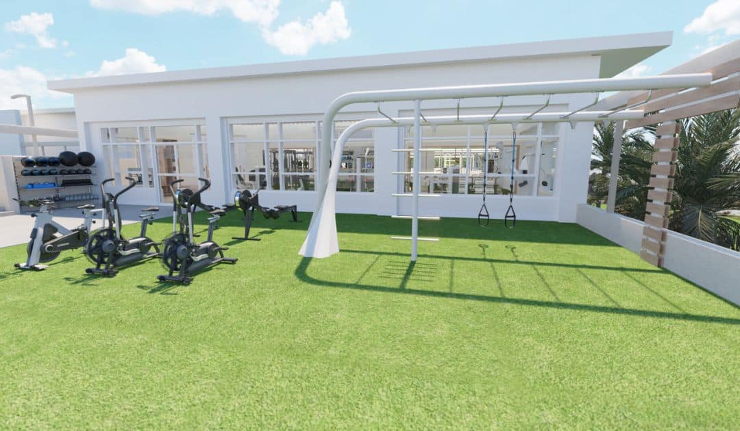 Hotel gym designed with a designated outdoor fitness space. 