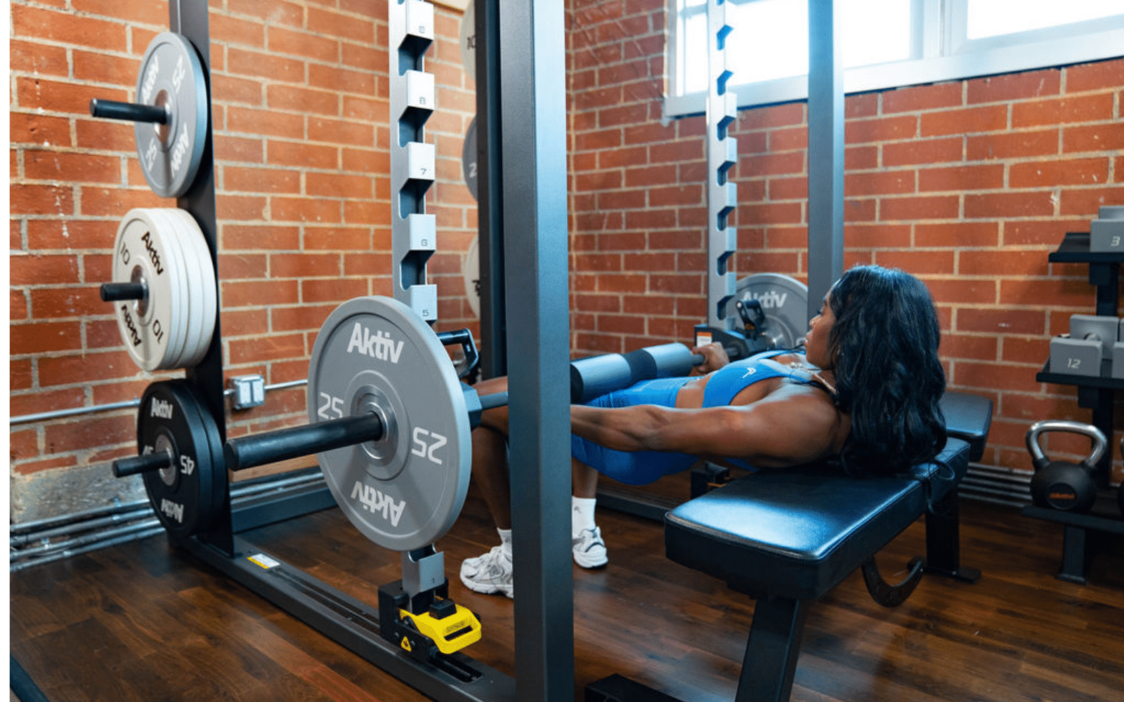 hip thrusts on smith machine by gym rax